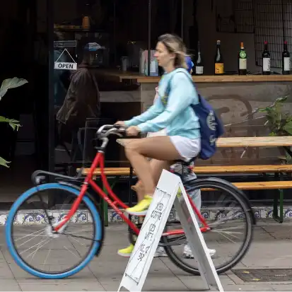 Young woman on bicycle in Hammersmith Young woman on bicycle in Hammersmith